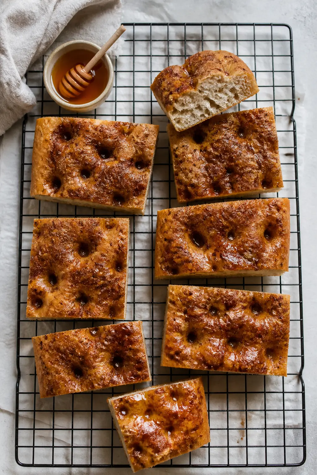 Overhead “tasty top view” of cinnamon focaccia on a cooling rack, cut into generous rectangles f