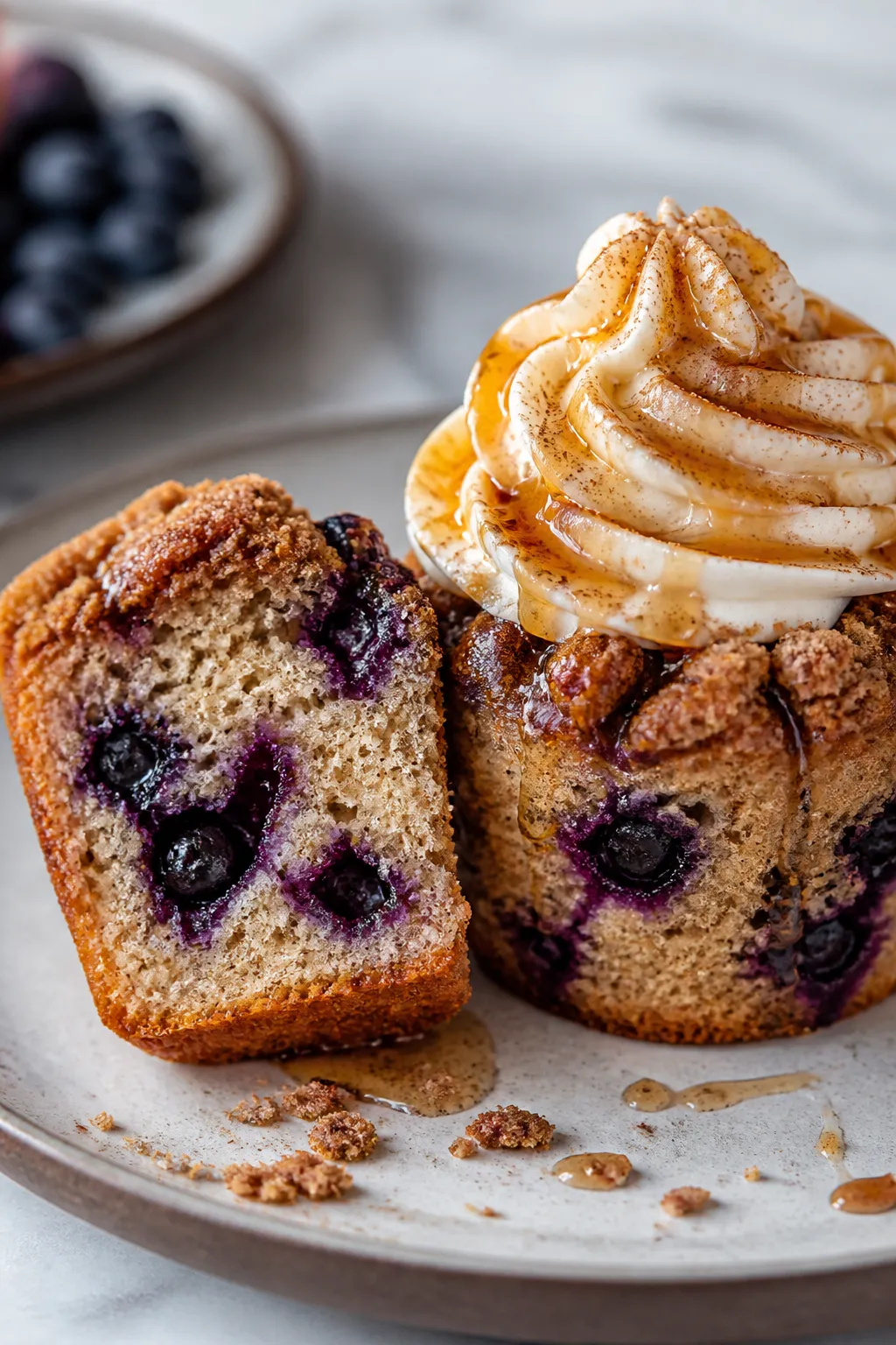 Close-up detail shot of a freshly baked Blueberry French Toast Cupcake sliced in half to reveal a te