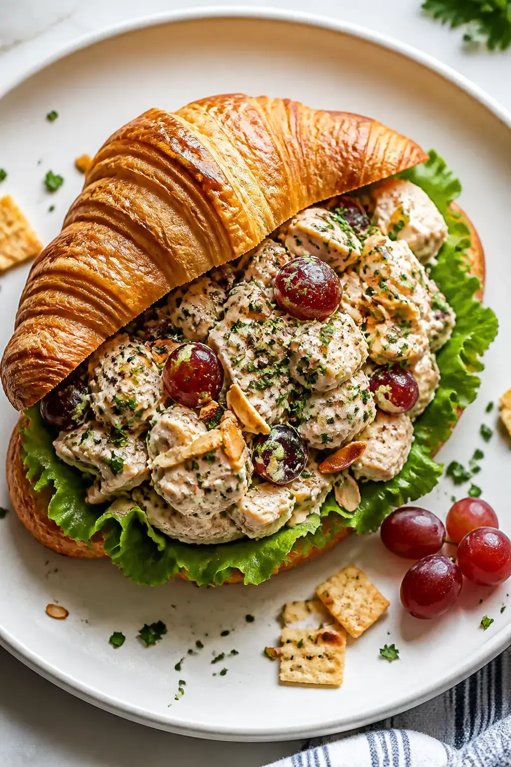 Final dish, tasty top view: Overhead shot of a generous scoop of chicken salad piled into a buttery 